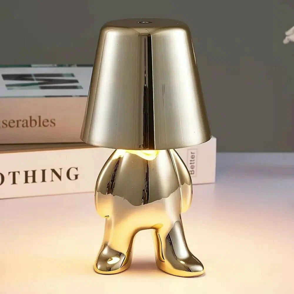 Gold modern figure table lamp with dome shade and metallic sculpted body
