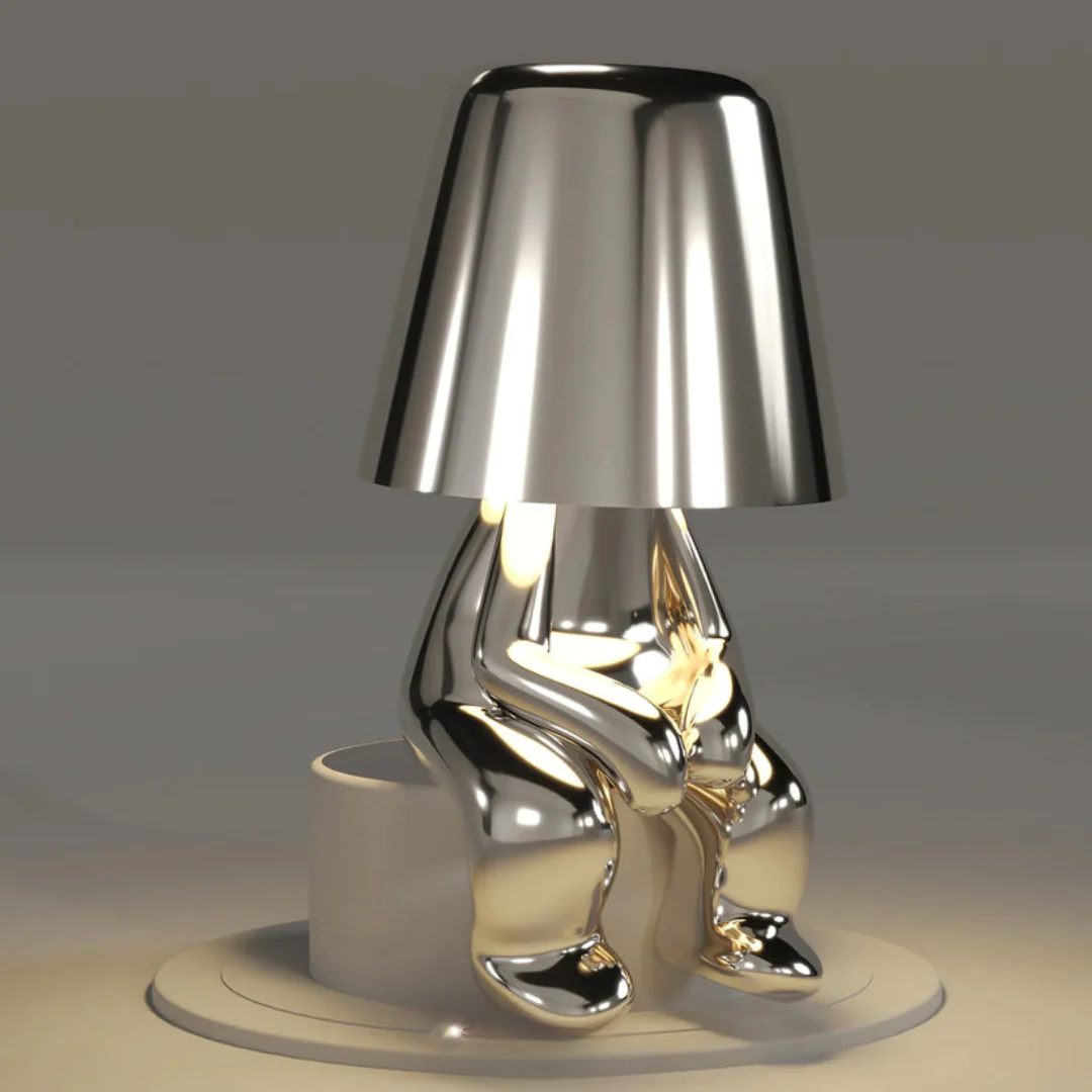 Silver figurine table lamp with conical shade and shiny character base, LED illumination