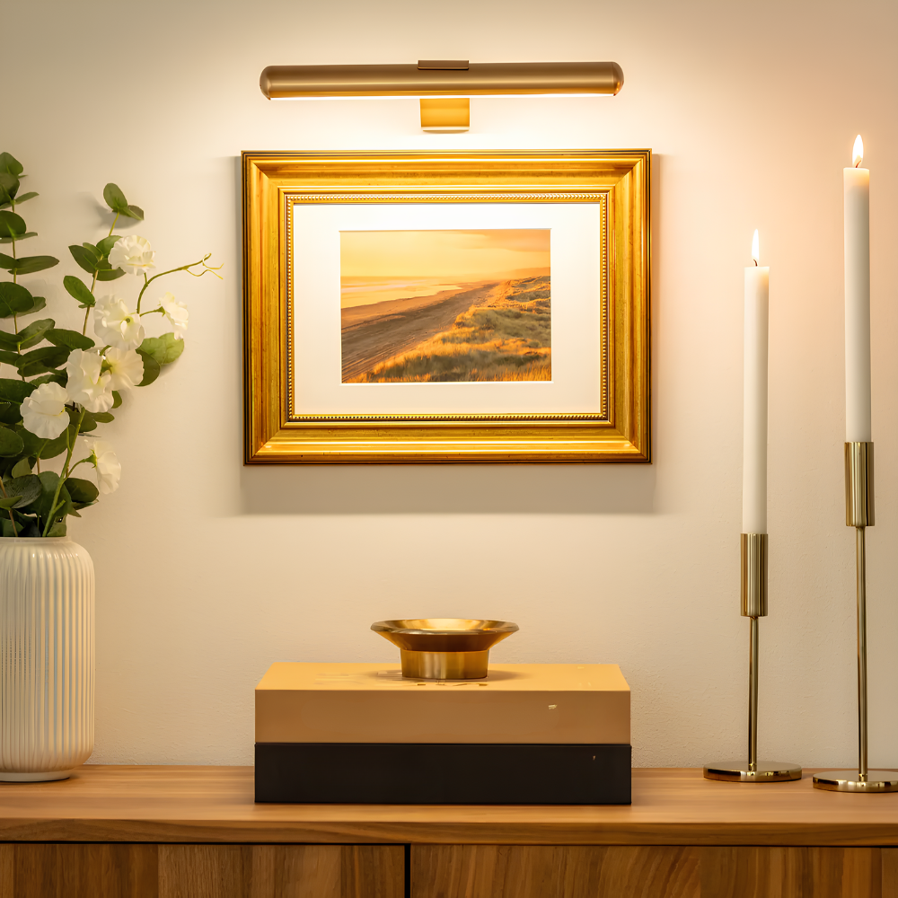 Gold LED picture wall sconce with a slim rounded bar and square wall mount.