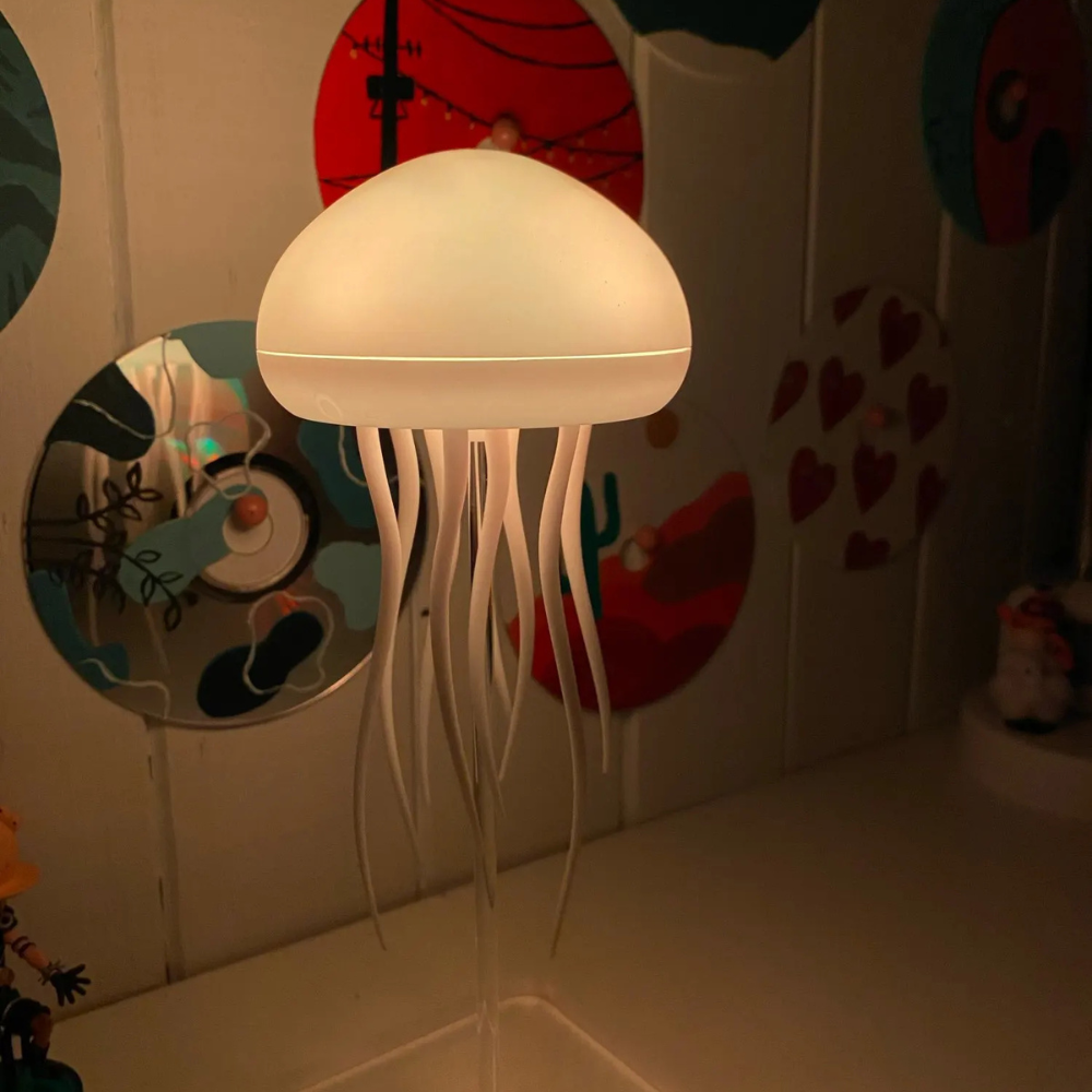 LED jellyfish night light with warm glowing dome and white tentacles