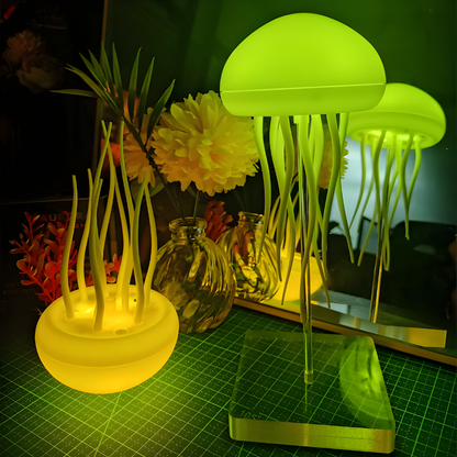 LED jellyfish night light with green glowing dome, base, and hanging tentacles