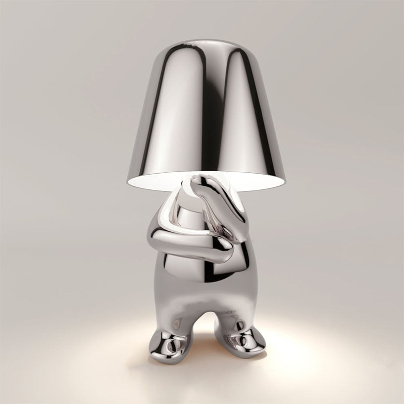 Silver figure table lamp with bell shade and side pose, glossy chrome finish