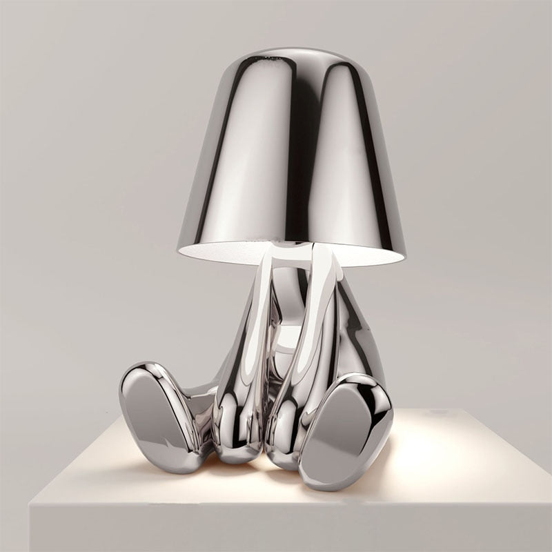 Silver figure table lamp with chrome dome shade and curved metallic legs