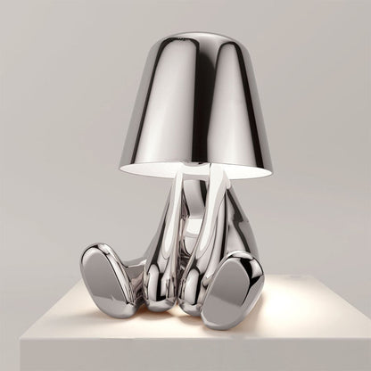 Silver figure table lamp with chrome dome shade and curved metallic legs