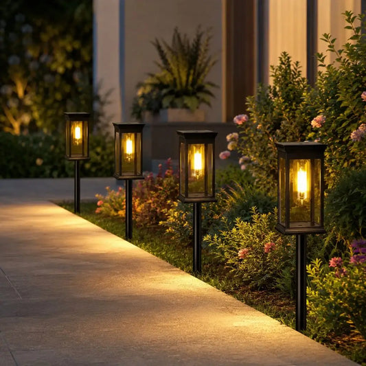 Solar garden pathway lantern lights on black posts with warm white glow