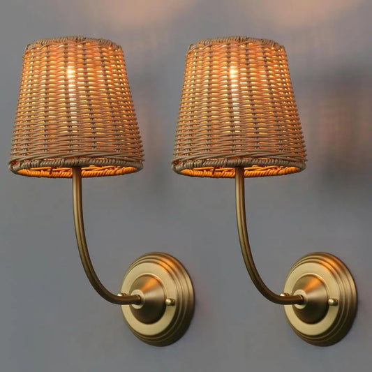 Pair of rattan wall lamps with woven shades and gold curved double-plate mounts