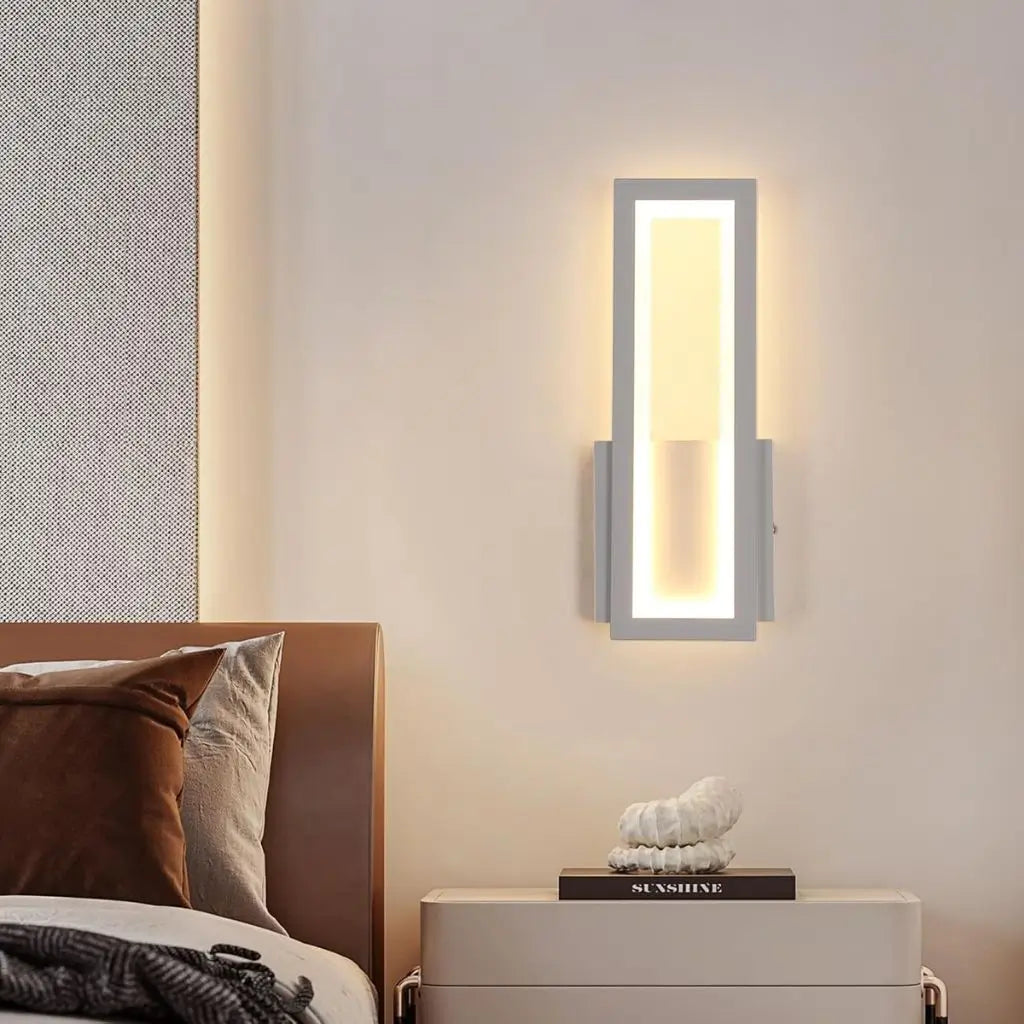 Wall-mounted LED wall light with white frame and warm-lit acrylic center panel