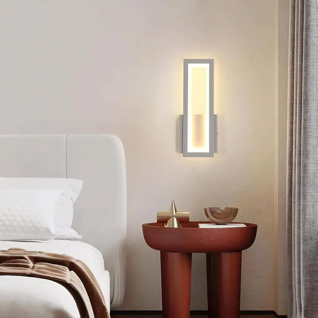 Wall-mounted LED light emitting warm glow through a white framed acrylic panel
