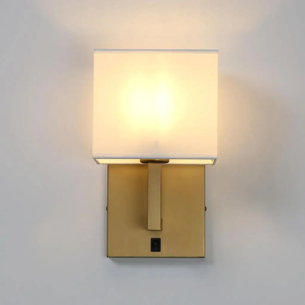 Antique gold wall sconce with white fabric lampshade and square switch panel