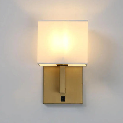 Antique gold wall sconce with white fabric lampshade and square switch panel