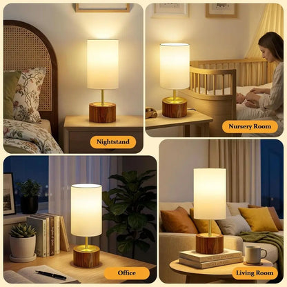 Table lamp with white fabric shade and faux wood base on a bedside table