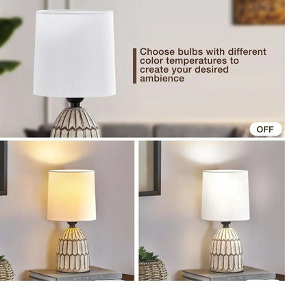 Ceramic table lamp with white fabric shade and patterned gold base, off and on
