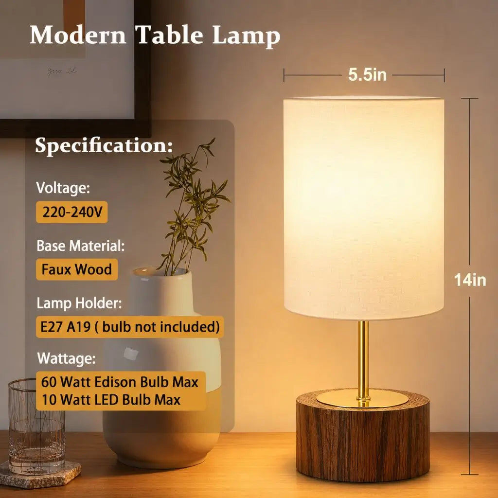 Modern table lamp with white fabric shade and faux wood base with brass center stem