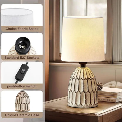 Ceramic table lamp with white fabric drum shade and patterned gold base