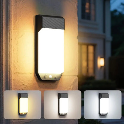 Outdoor wall-mounted motion sensor light in black with frosted white glow