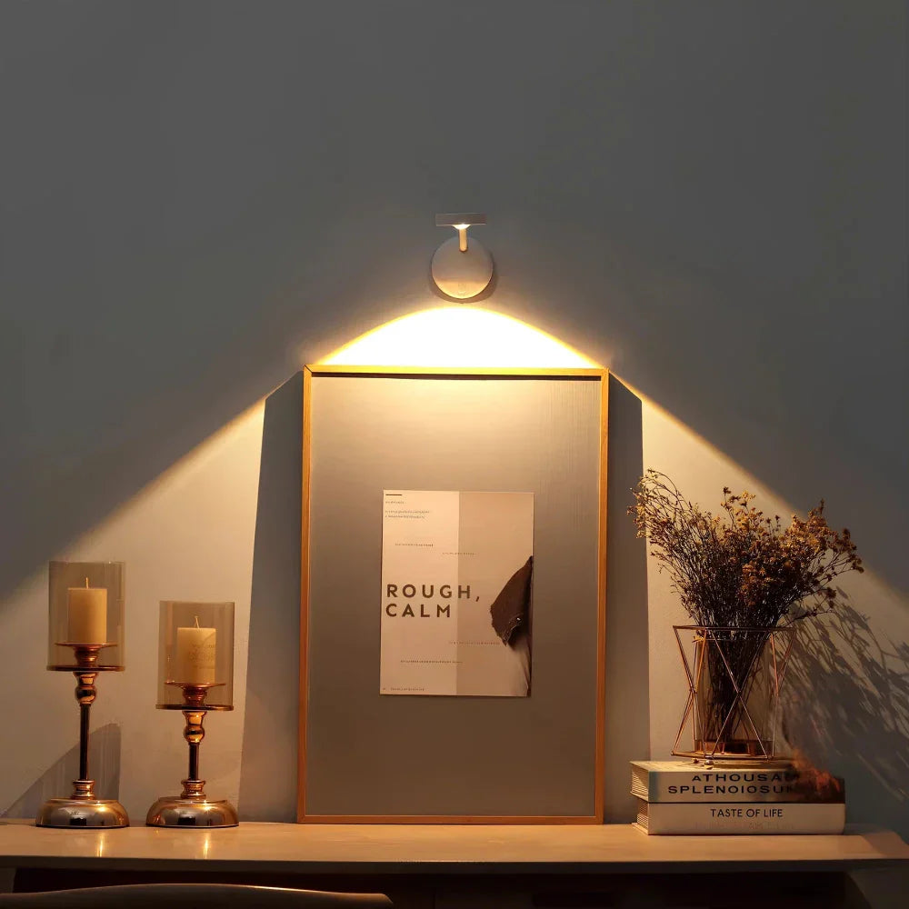 Wireless motion sensor LED wall light casting warm glow above decor items