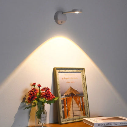 Wireless motion sensor LED wall light casting warm halo glow above flowers