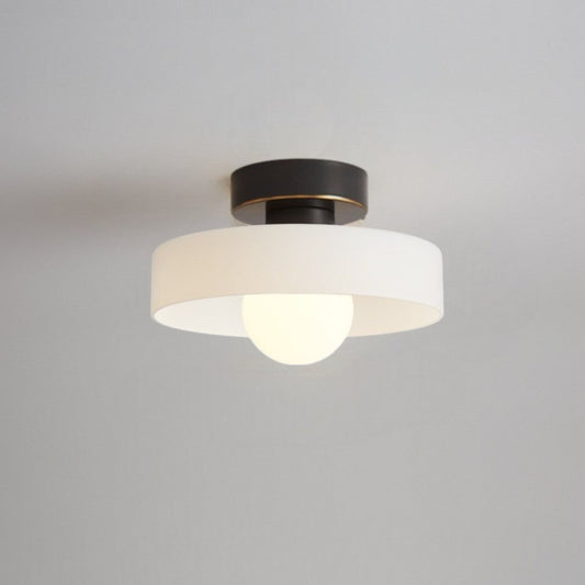 Ceiling light with round white glass shade and dark metal top, with glowing bulb