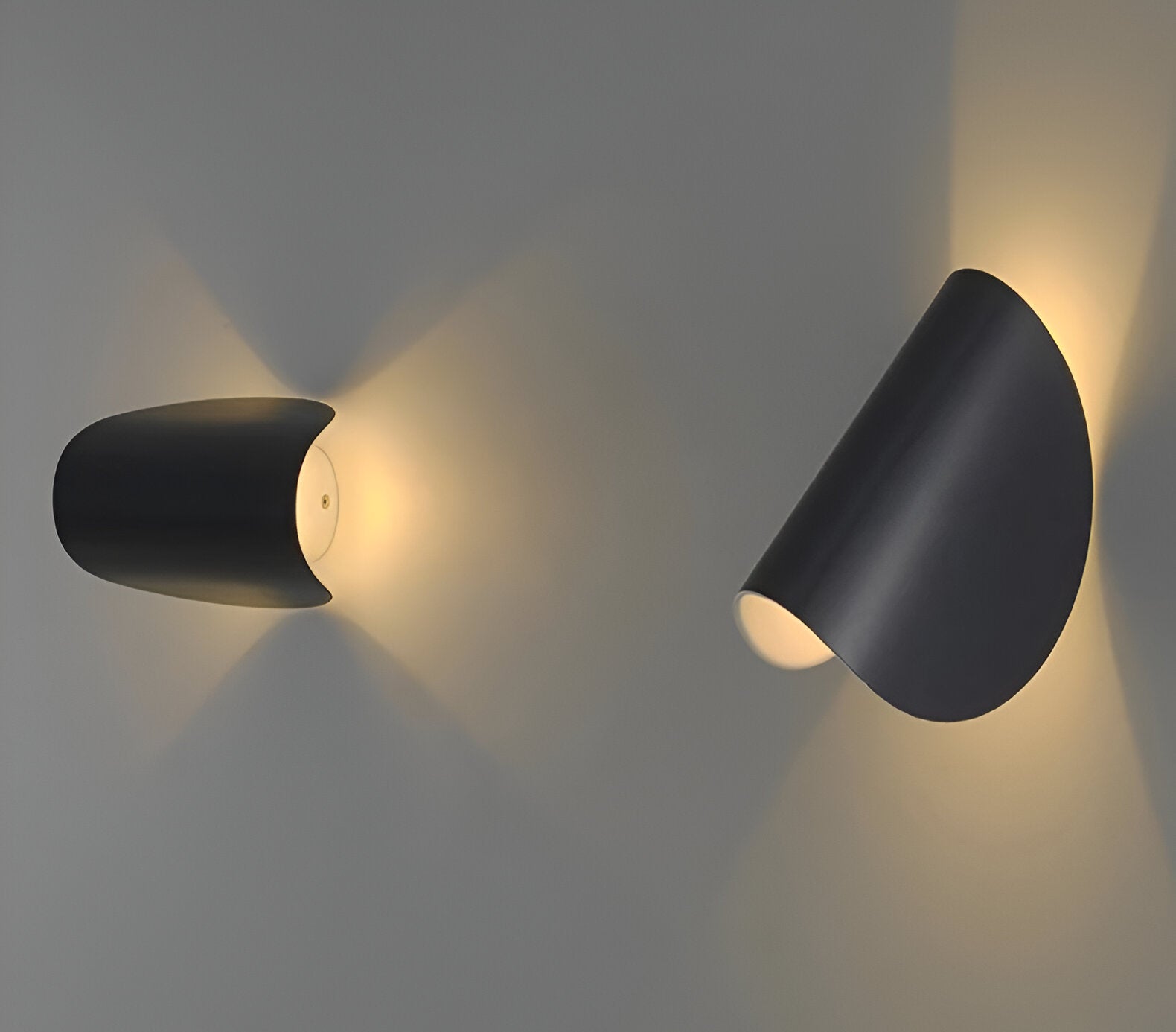 Adjustable metal wall light set with matte black cone shades, angled to cast warm light.