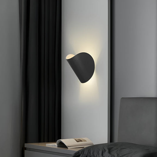Adjustable metal wall light with black cone shades, angled for directed warm light.