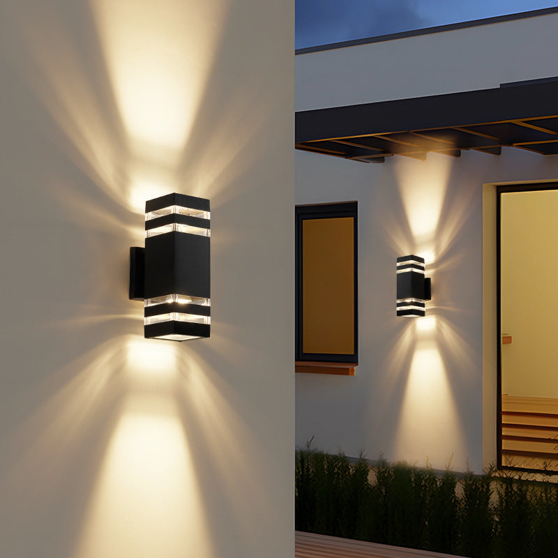 Exterior wall light with aluminum trim, dark glass, stacked horizontal bands, glowing