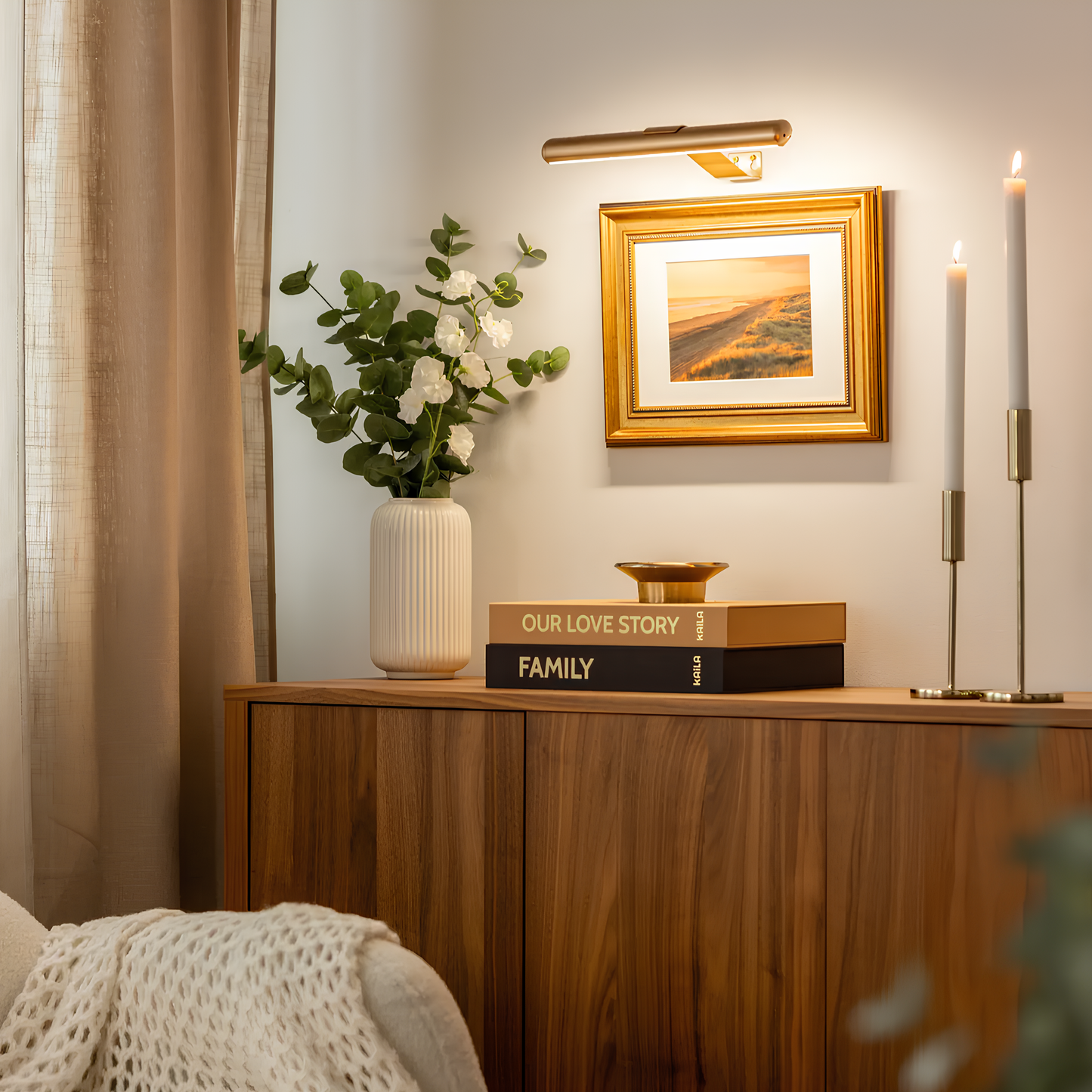 Gold LED picture wall light with a slim bar housing and vertical wall bracket.