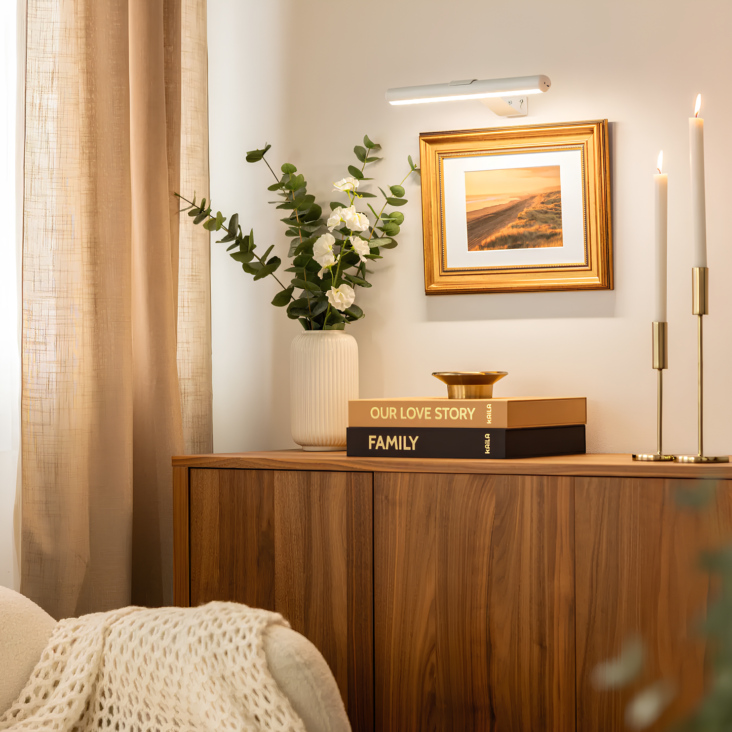 Cordless LED picture wall lamp with slim white bar, mounted above framed landscape art