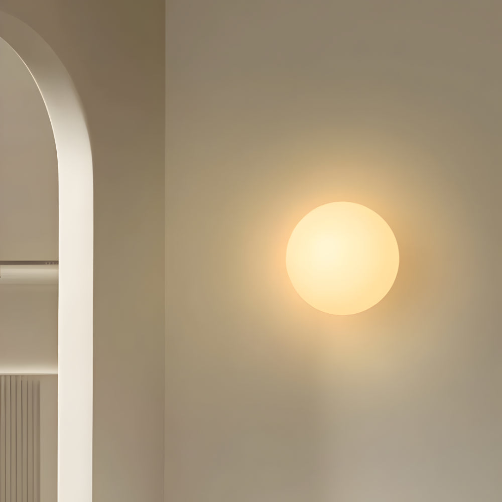 Round warm white glass wall light with globe diffuser