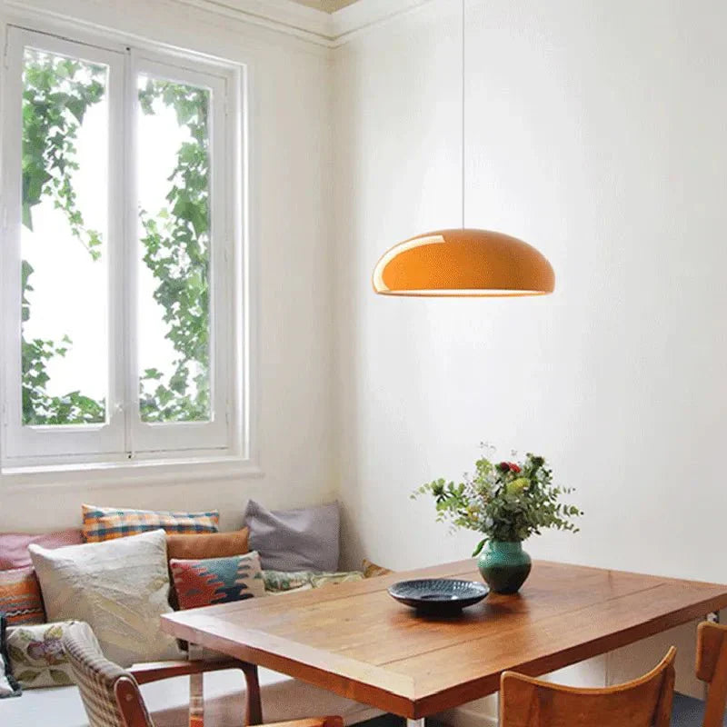 Modern metal and acrylic pendant light with small orange oval shade