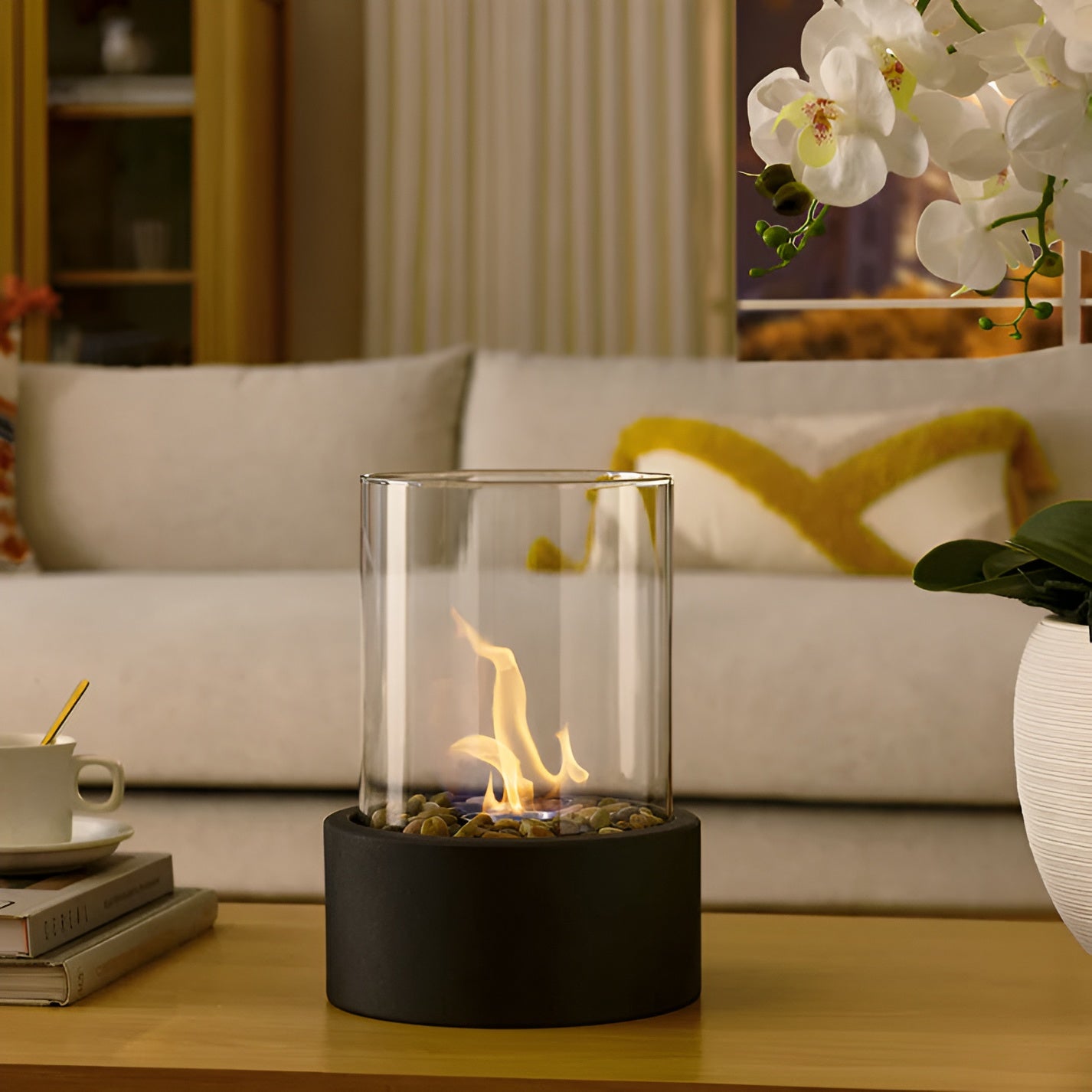 Tabletop bioethanol fireplace with clear glass fire bowl and black metal base, small flame