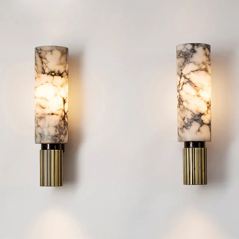Wall light with marble-effect glass cylinder shade, black mount, gold ribbed metal base