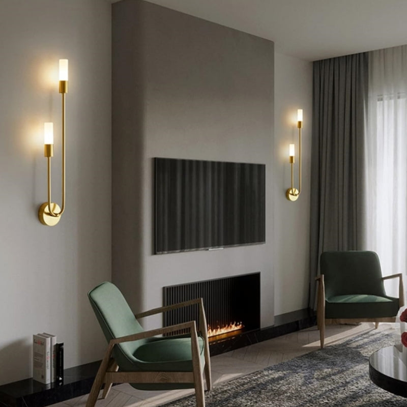 Gold LED wall lights with warm white cylinder shades and curved circular backplates