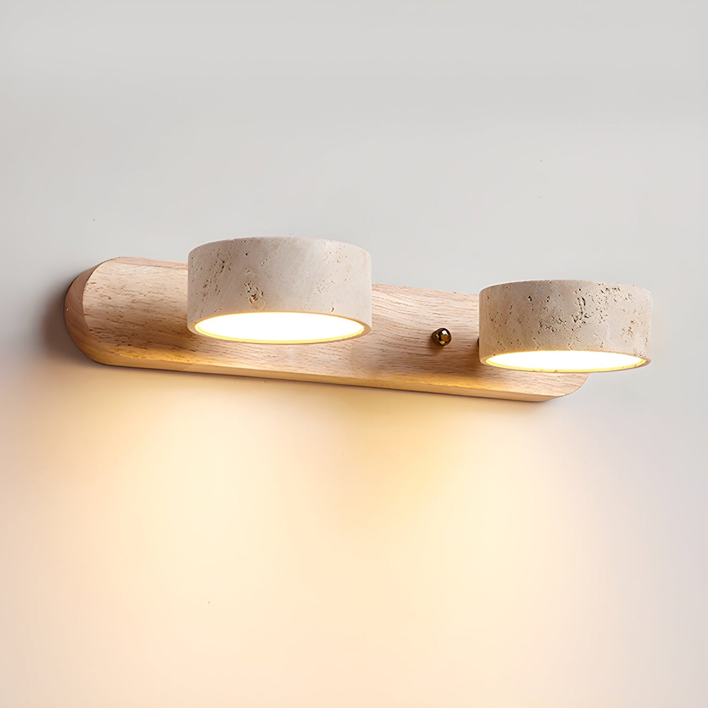 Wall LED light with natural wood bar and two speckled stone-look cylinder shades, warm glow