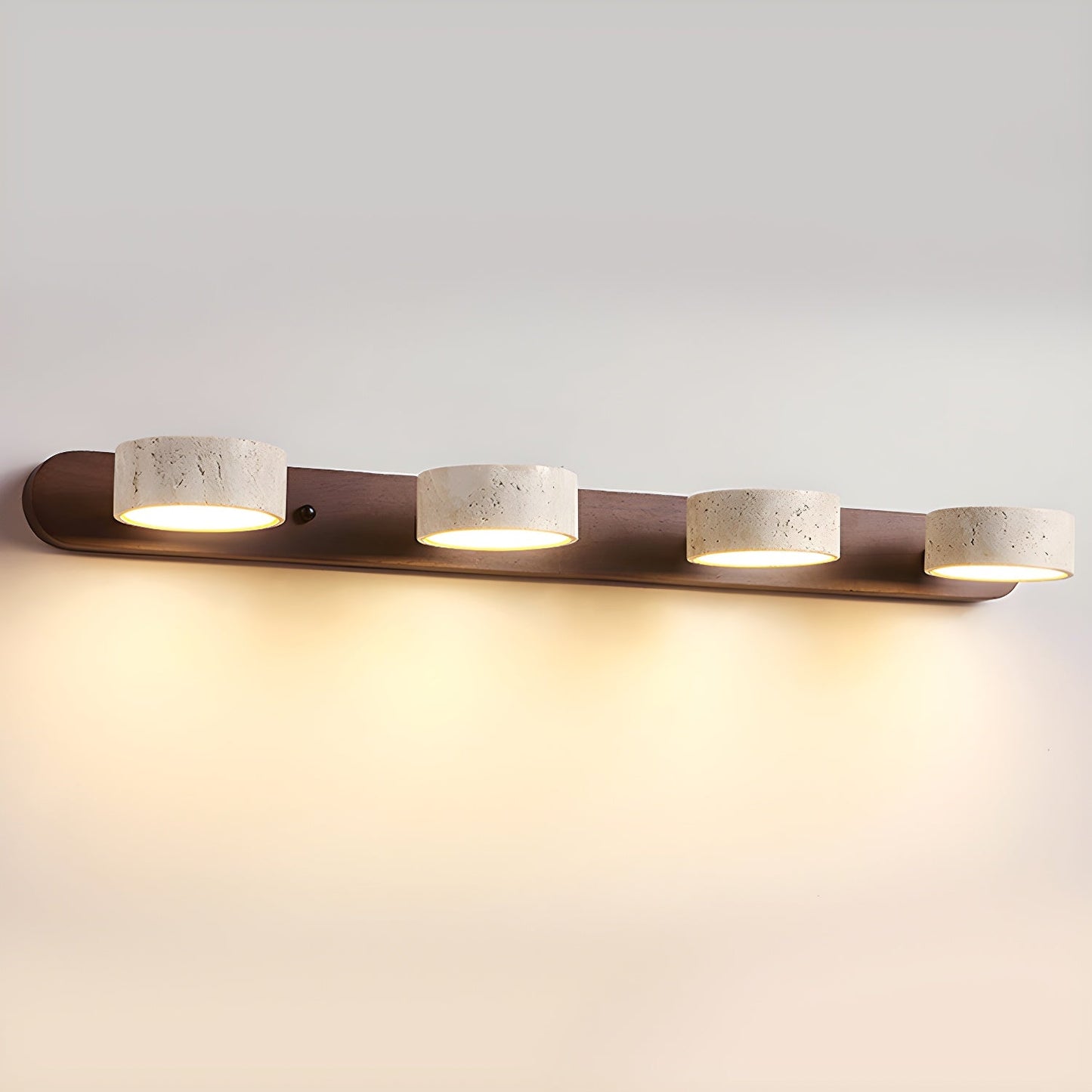 Wall LED light with walnut bar and four speckled stone-look cylinder shades, warm glow