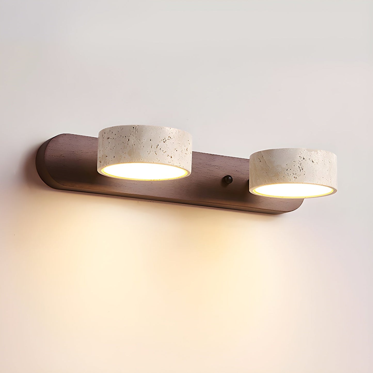 Wall LED light with walnut bar and two speckled stone-look cylinder shades, warm glow