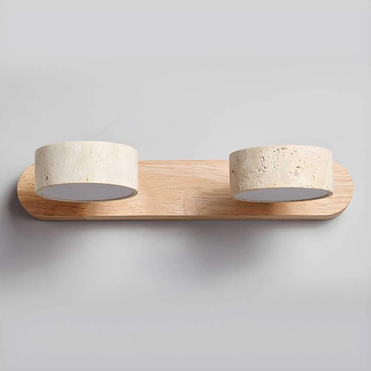 LED wall light with three stone-look cylinder shades on a wood-look wall bar