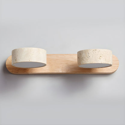 LED wall light with three stone-look cylinder shades on a wood-look wall bar