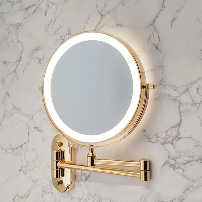 Wall-mounted round cosmetic mirror with gold frame and LED ring on wall bracket