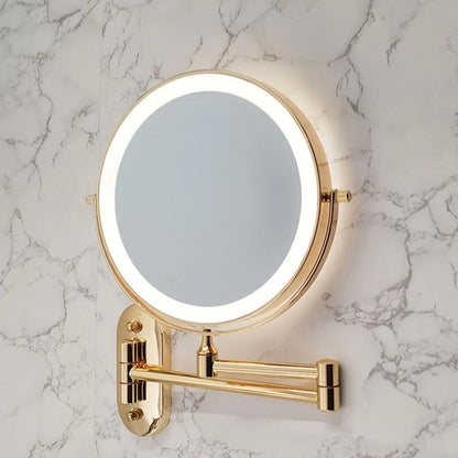 Wall-mounted round cosmetic mirror with gold frame and LED ring on wall bracket