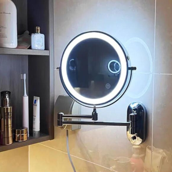 Round LED magnifying wall mirror with glowing white rim and dark metal mount arm