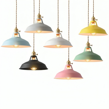 Assorted colorful metal pendant lights with brass caps and exposed bulbs under cones