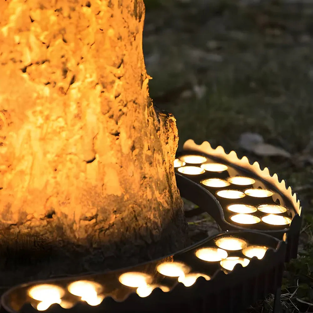 Solar LED garden spotlight close-up lighting tree trunk with warm LEDs