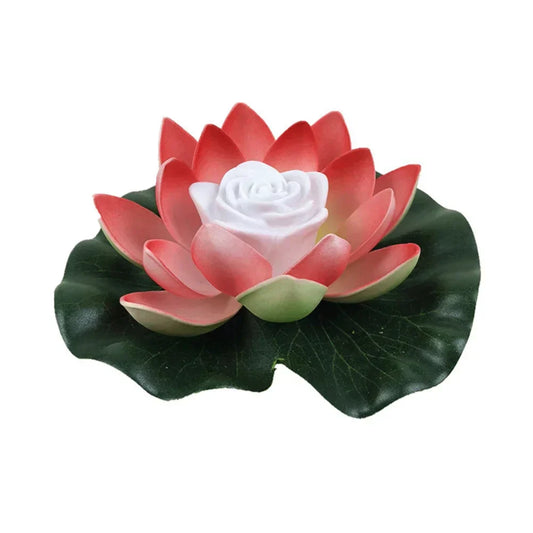 Floating lotus LED pond light with red petals, white center, and dark green leaves