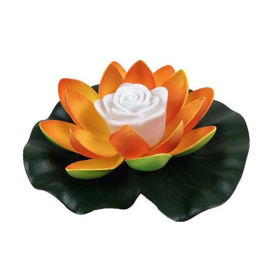 Floating lotus LED pond light with orange and yellow petals, white center, dark green leaves