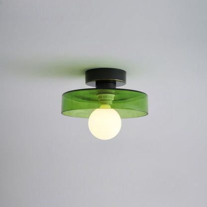 Ceiling light with round green glass shade and dark metal top, bulb centered