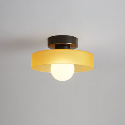 Ceiling light with round amber glass shade and gold metal top, soft glow bulb
