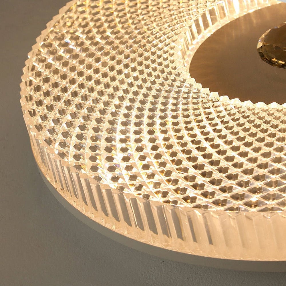 Angled close-up of circular acrylic LED ceiling light with textured crystal-like mesh