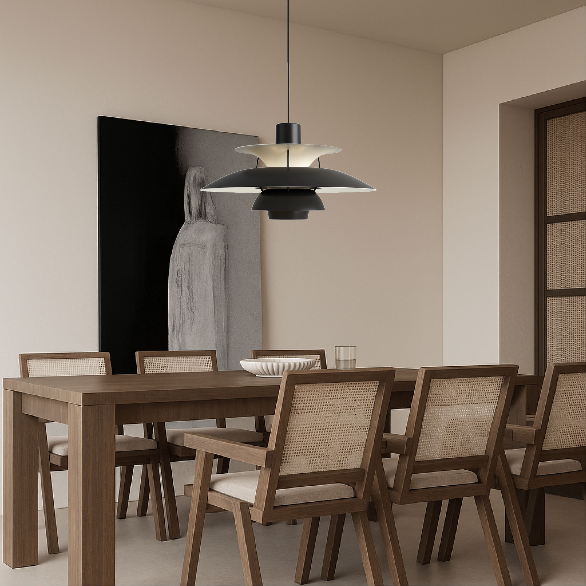 Black pendant light with layered metal shades above dining set