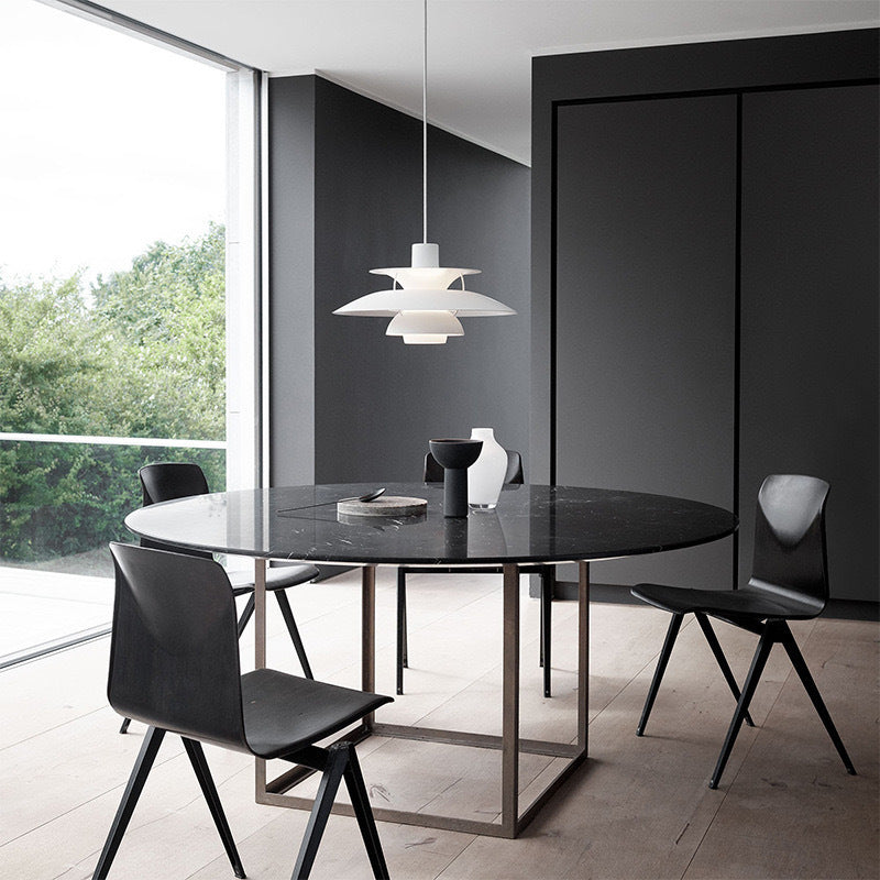 Small white pendant light with layered shades in minimalist room