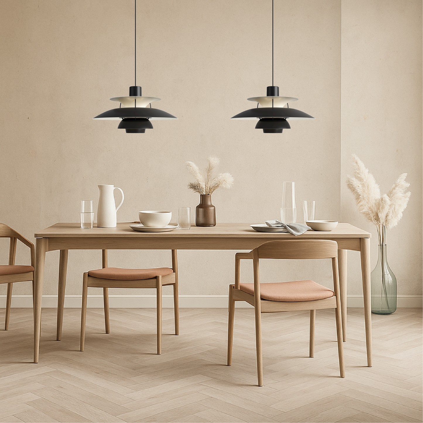 Two black pendant lights with layered dome shades over dining table
